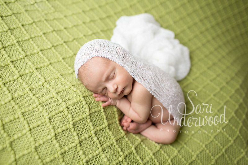 newborn baby girl in white wrap