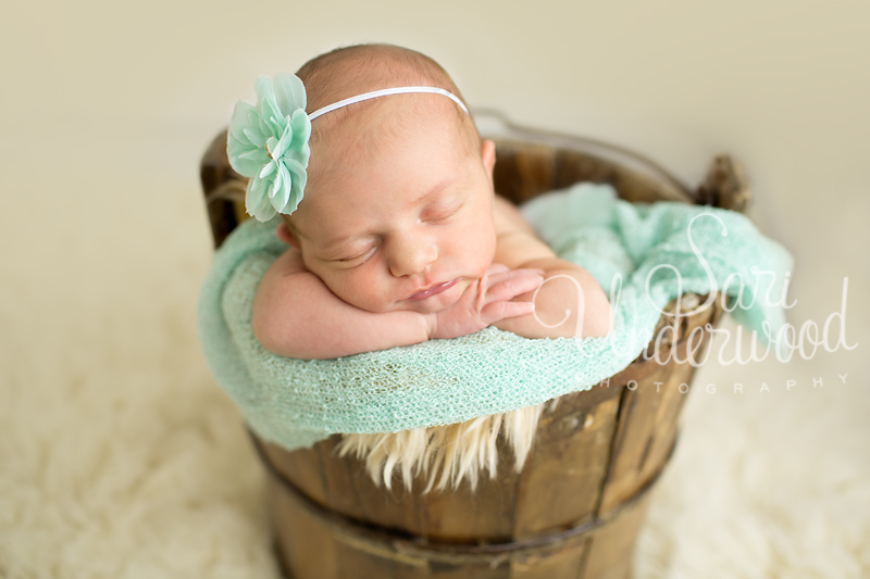 newborn baby girl in a bucket