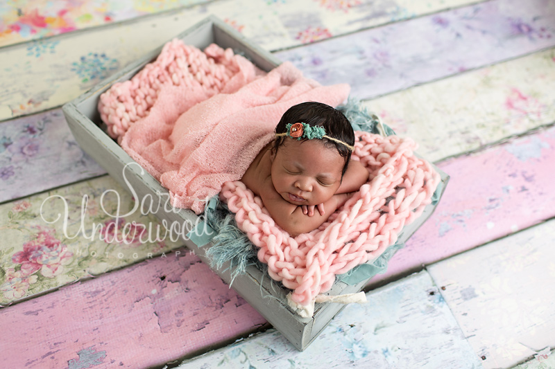 10 day old baby girl in pretty soft pastels